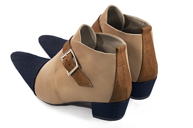 Women's navy blue, tan beige and caramel brown elegant ankle boots, with buckles at the front. Tapered toe. Low cone heels - Rear view